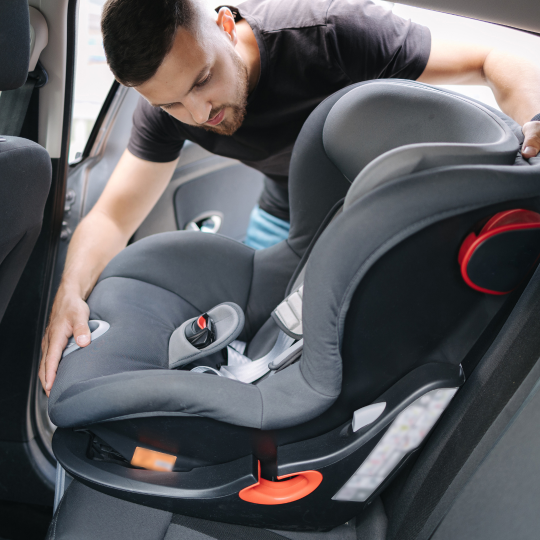 Dad unloading baby gear from the car, Baby Space helps keep space clear for strollers, diaper bags, and car seats.