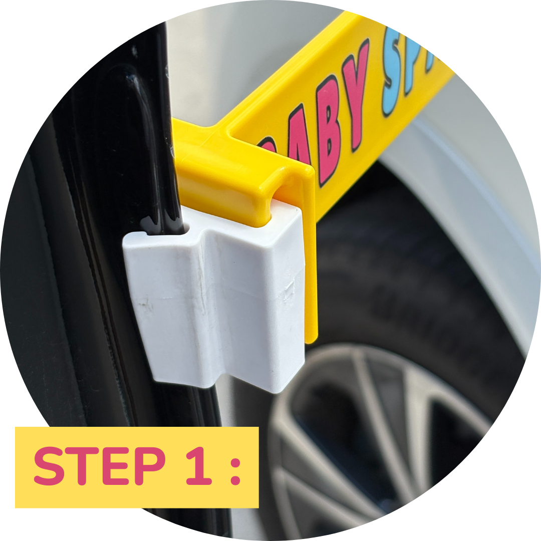 Step one: Attaching the Baby Space car seat sign using the secure clip on the edge of the car door.
