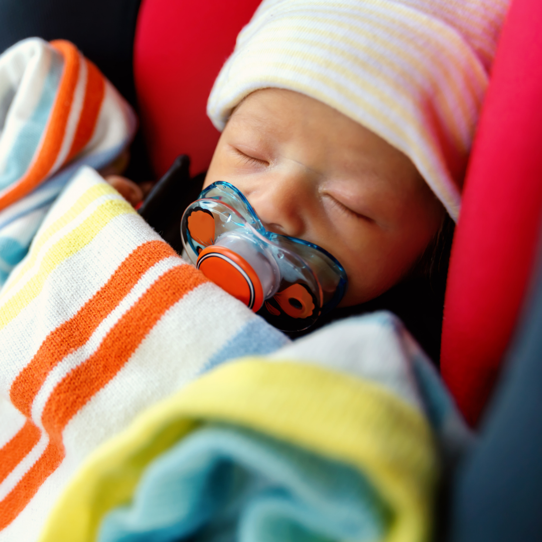 Newborn baby safely loaded into his car seat with Baby Space